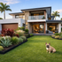 YardSteel blck galvanised edging professional photo with a modern Australian home and french bulldog on the lawn.